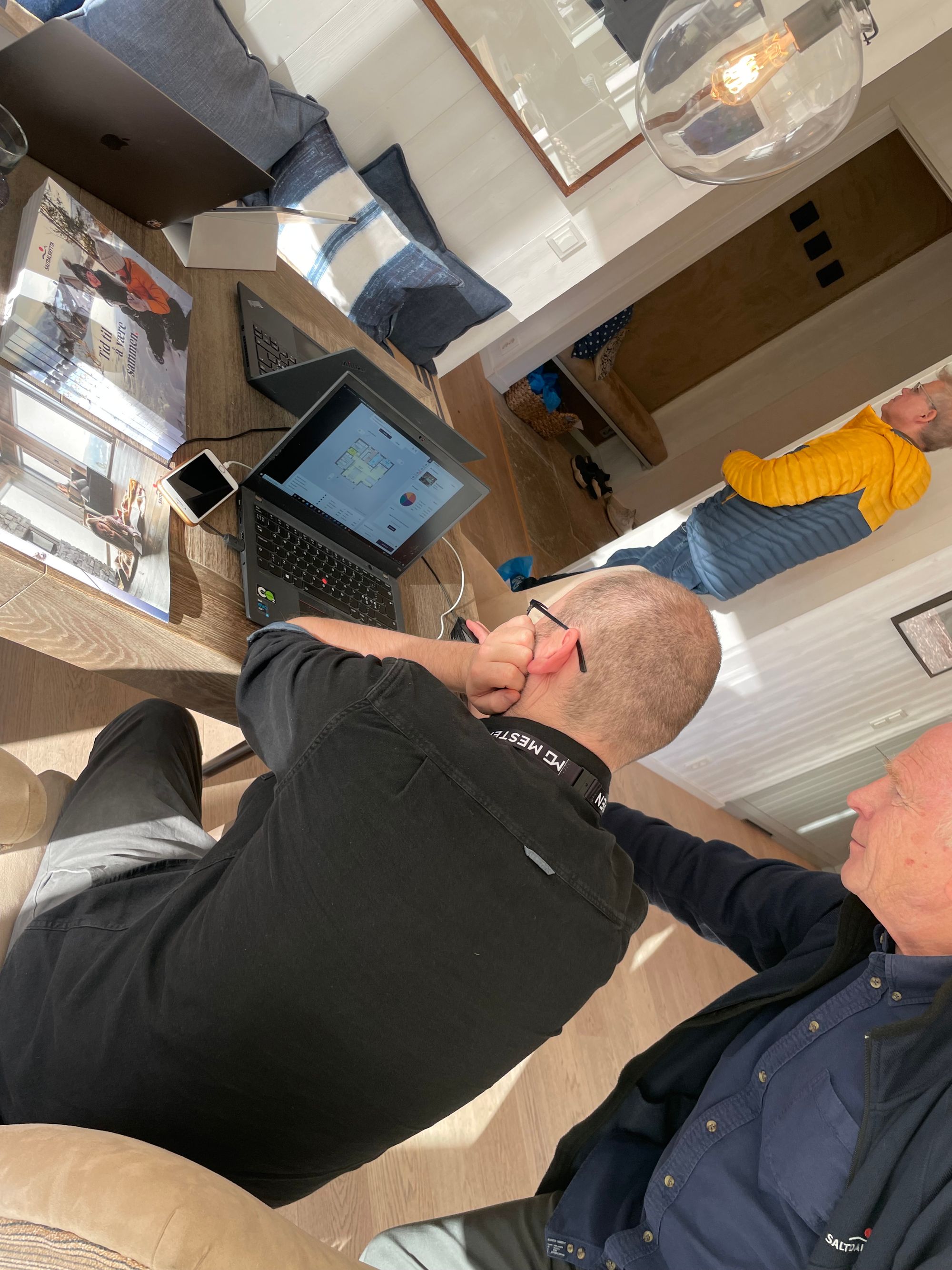 Two men looking at a laptop during a user testing workshop 